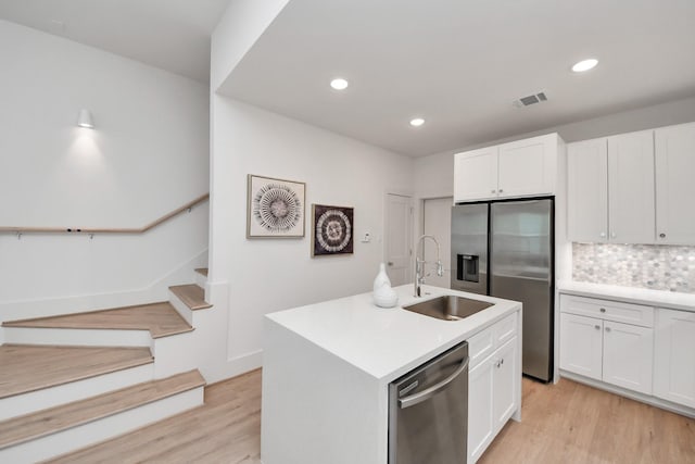 1049 Glenn Ave, Houston, TX 77088 - kitchen with a sink, visible vents, appliances with stainless steel finishes, and light wood finished floors