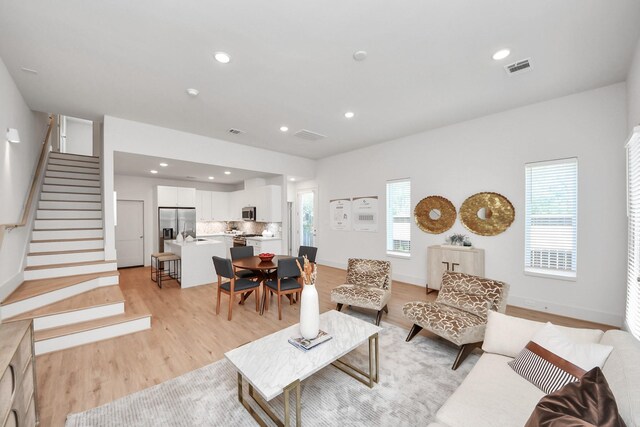 1049 Glenn Ave, Houston, TX 77088 - living room with recessed lighting, stairway, light wood-style floors, and visible vents