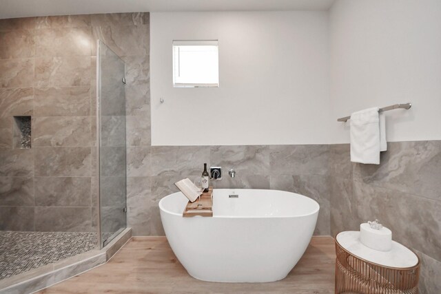 1049 Glenn Ave, Houston, TX 77088 - full bath featuring a shower stall, a freestanding tub, and tile walls