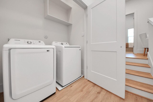 1049 Glenn Ave, Houston, TX 77088 - washroom with light wood-type flooring, separate washer and dryer, and laundry area
