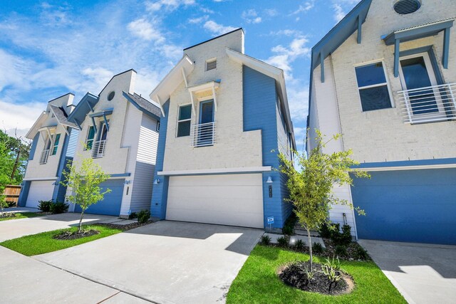 1049 Glenn Ave, Houston, TX 77088 - contemporary home featuring concrete driveway and an attached garage