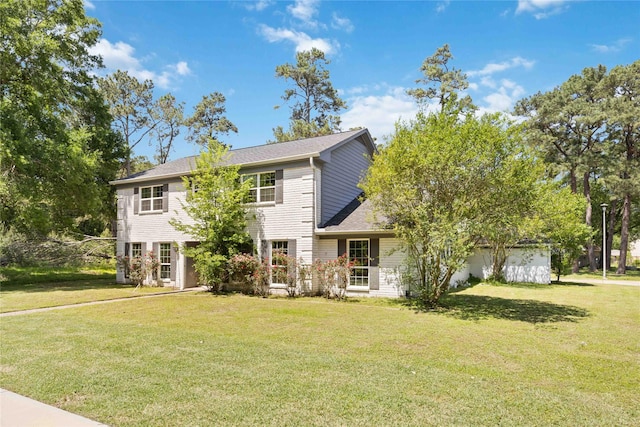 colonial-style house featuring a front lawn