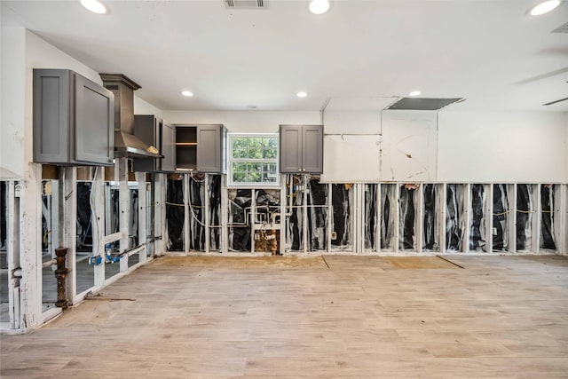 empty room featuring recessed lighting, visible vents, and light wood finished floors