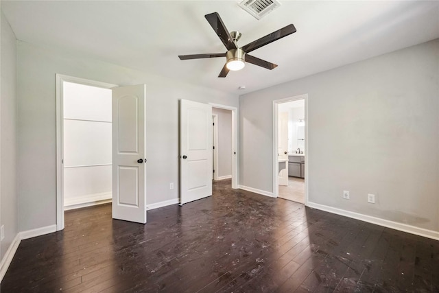 unfurnished bedroom featuring baseboards, visible vents, ceiling fan, hardwood / wood-style floors, and connected bathroom