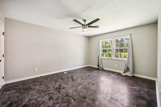 empty room with baseboards, a ceiling fan, and hardwood / wood-style floors