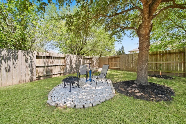 view of yard with a fire pit and a fenced backyard