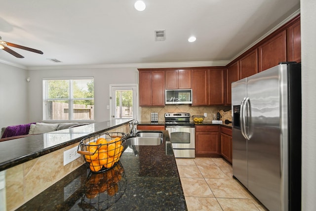 kitchen featuring ceiling fan, visible vents, a sink, ornamental molding, and stainless steel appliances