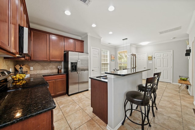 kitchen featuring crown molding, appliances with stainless steel finishes, light tile patterned floors, tasteful backsplash, and visible vents