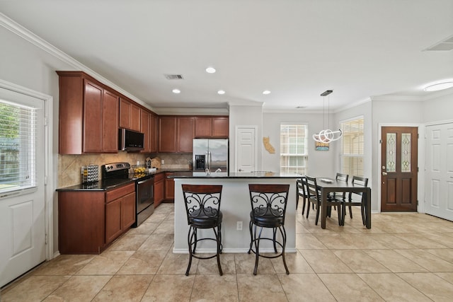 kitchen featuring visible vents, crown molding, dark countertops, and stainless steel appliances