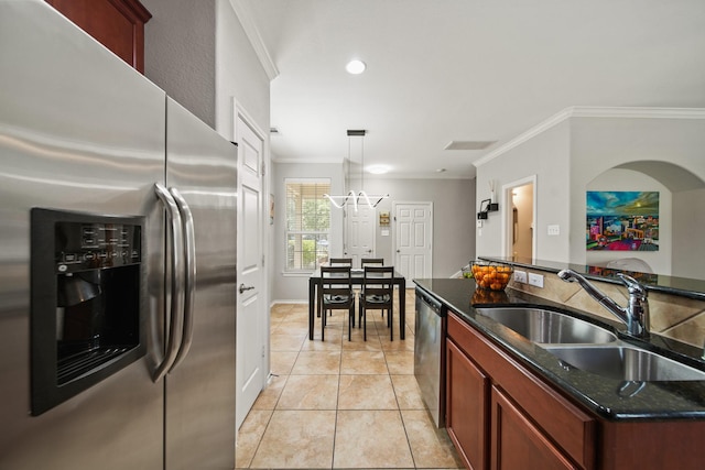 kitchen featuring decorative light fixtures, a sink, light tile patterned floors, ornamental molding, and stainless steel appliances