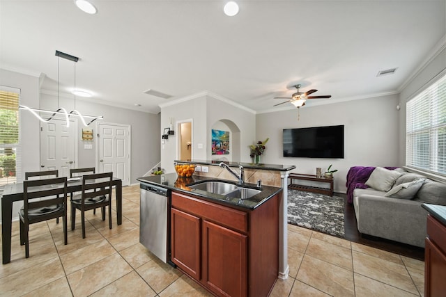 kitchen featuring stainless steel dishwasher, a sink, a healthy amount of sunlight, and open floor plan
