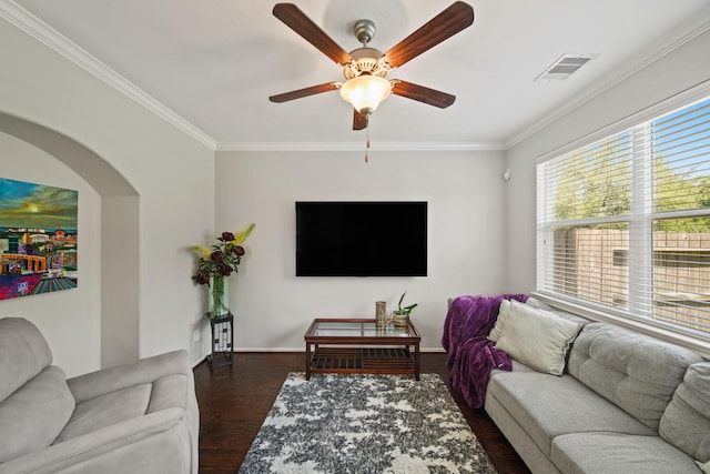 living area featuring crown molding, ceiling fan, baseboards, wood finished floors, and visible vents