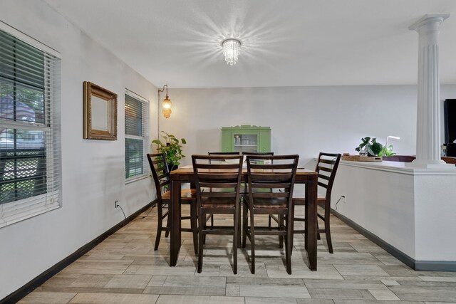 8319 Lemongrass Ave, Baytown, TX 77521 - dining area featuring light wood-style floors, baseboards, and decorative columns