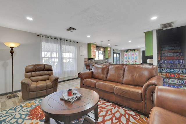 living area with recessed lighting, light wood-type flooring, and visible vents