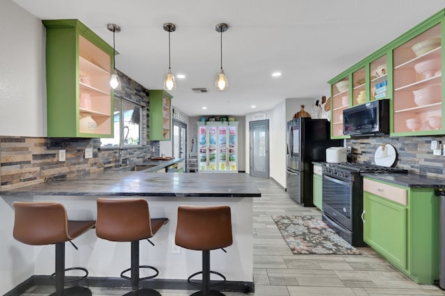 kitchen with a sink, green cabinetry, stainless steel gas range, open shelves, and black microwave