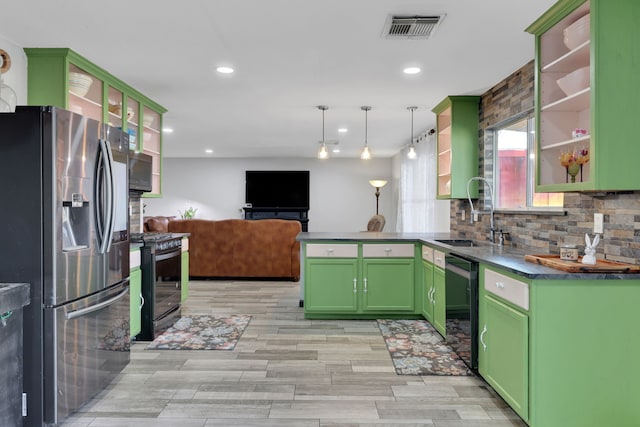 kitchen with range with gas cooktop, open shelves, stainless steel refrigerator with ice dispenser, green cabinetry, and visible vents