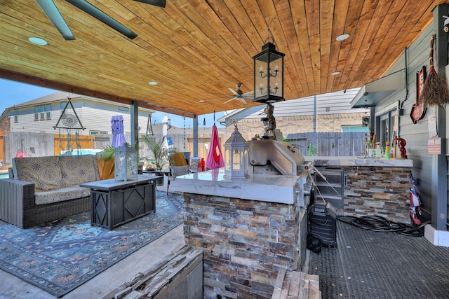 8319 Lemongrass Ave, Baytown, TX 77521 - view of patio featuring fence, area for grilling, outdoor wet bar, an outdoor living space, and a ceiling fan