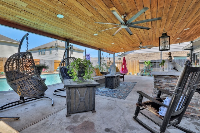 8319 Lemongrass Ave, Baytown, TX 77521 - view of patio / terrace with a fire pit, outdoor dry bar, a fenced backyard, ceiling fan, and a fenced in pool
