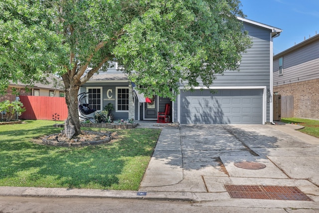obstructed view of property with fence, driveway, a front lawn, and a garage