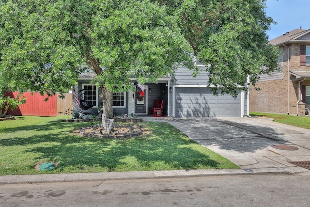 obstructed view of property with a garage, a front yard, and concrete driveway