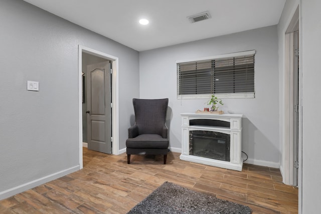 8319 Lemongrass Ave, Baytown, TX 77521 - sitting room with baseboards, visible vents, and wood finished floors