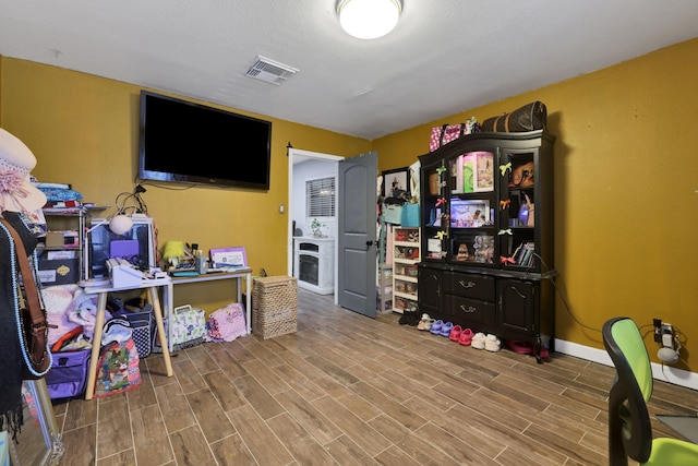 8319 Lemongrass Ave, Baytown, TX 77521 - playroom featuring visible vents, wood finished floors, baseboards, and a fireplace
