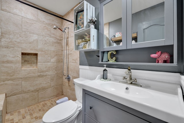8319 Lemongrass Ave, Baytown, TX 77521 - bathroom featuring a wainscoted wall, vanity, toilet, and tiled shower
