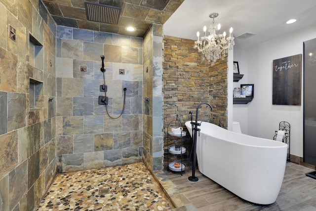8319 Lemongrass Ave, Baytown, TX 77521 - bathroom with tiled shower, visible vents, a chandelier, and a freestanding bath