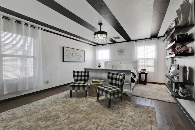 8319 Lemongrass Ave, Baytown, TX 77521 - bedroom featuring a chandelier, a textured ceiling, baseboards, and wood finished floors