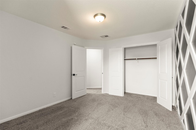 unfurnished bedroom featuring a closet, carpet flooring, visible vents, and baseboards
