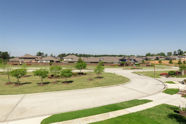 view of property's community featuring a yard and a residential view