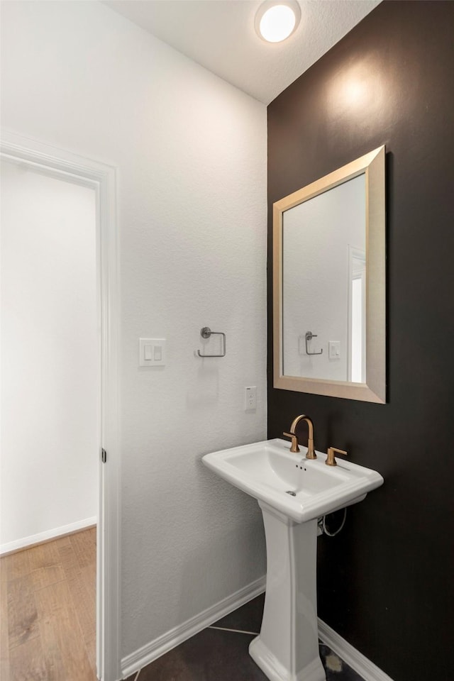 bathroom featuring baseboards and wood finished floors