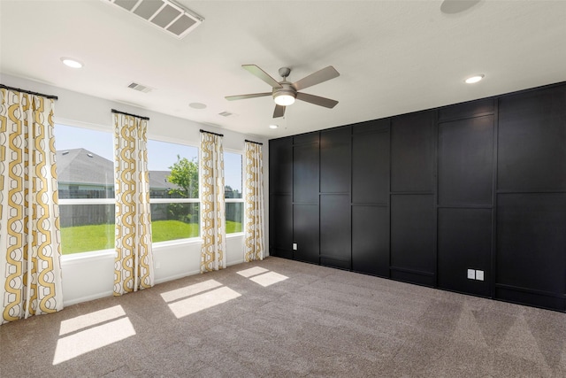 carpeted spare room featuring ceiling fan, visible vents, and recessed lighting