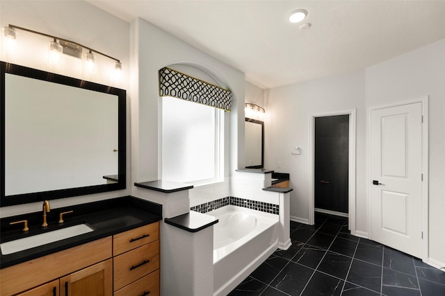 bathroom featuring vanity, a bath, and baseboards
