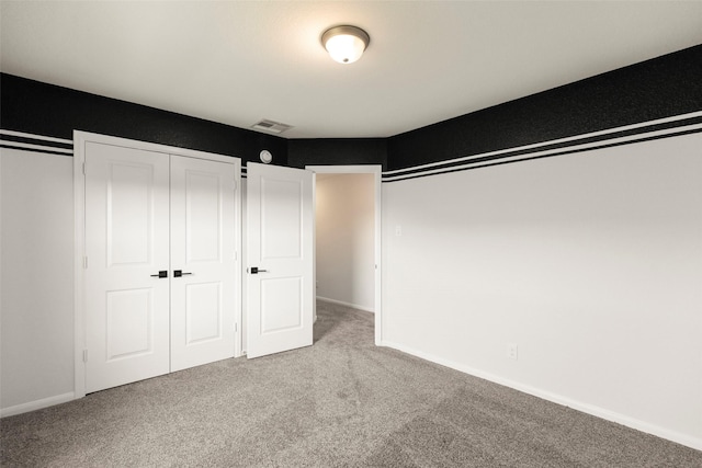 unfurnished bedroom with visible vents, baseboards, and carpet flooring