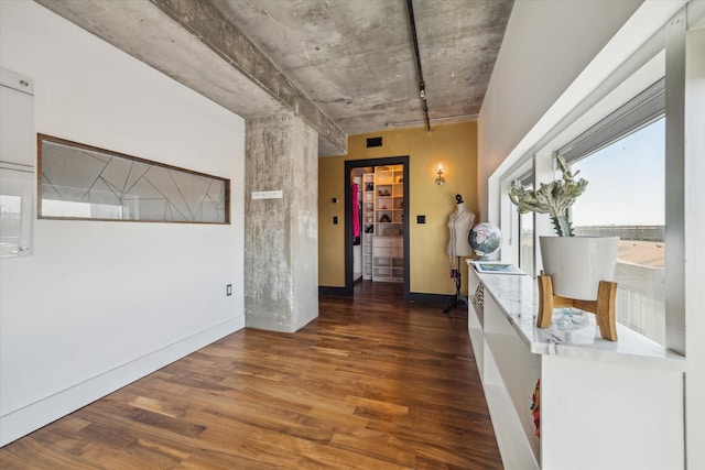 interior space with baseboards and wood finished floors