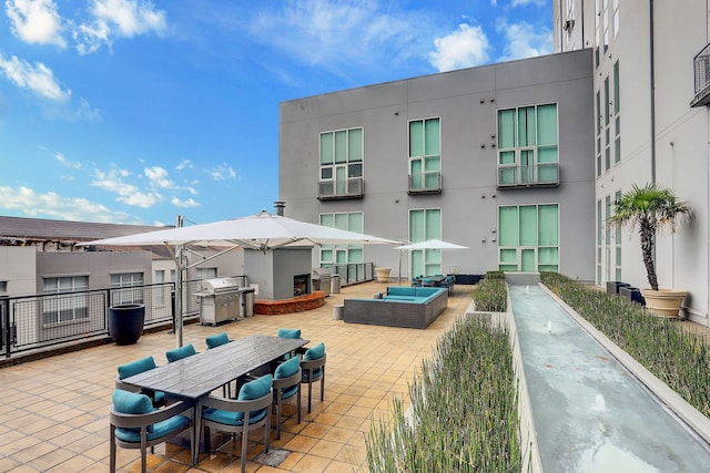 view of property's community featuring outdoor dining area, an outdoor living space, and a patio area