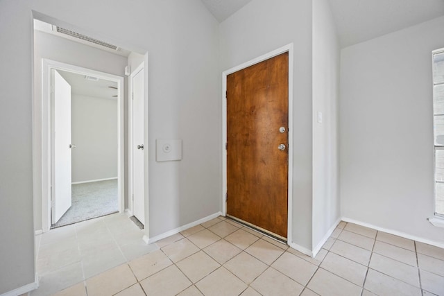 foyer entrance featuring visible vents, baseboards, and light tile patterned floors