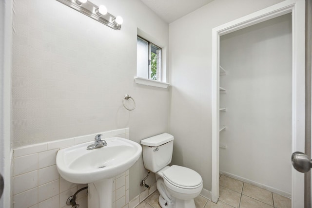 bathroom featuring toilet and tile patterned floors