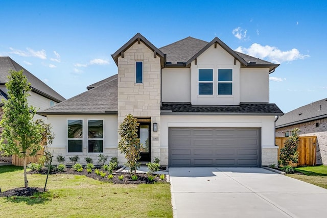 view of front of house with driveway, fence, a front lawn, stone siding, and stucco siding