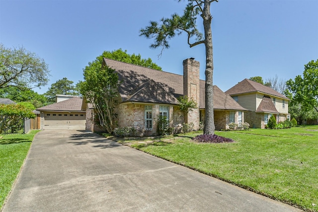 view of front of home with a front lawn, fence, and a garage