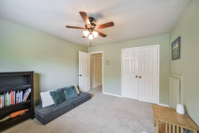 living area featuring baseboards, carpet floors, and ceiling fan