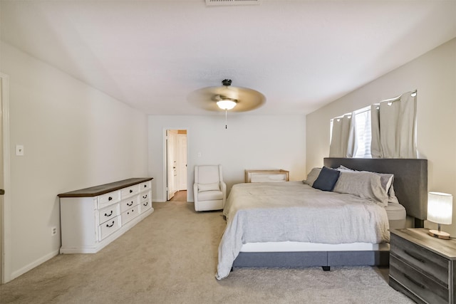 bedroom featuring light carpet, visible vents, and ceiling fan