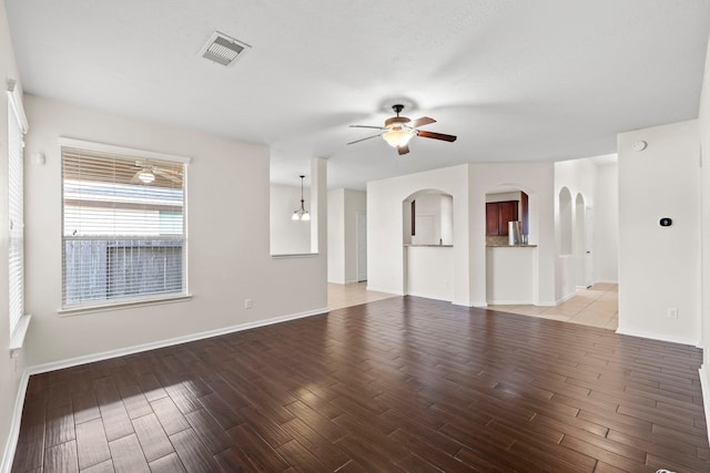unfurnished living room with visible vents, a ceiling fan, baseboards, and light wood-style flooring