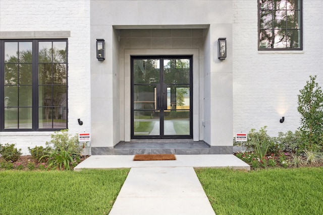 534 Lanecrest Ln, Houston, TX 77024 - entrance to property featuring french doors, brick siding, and a lawn