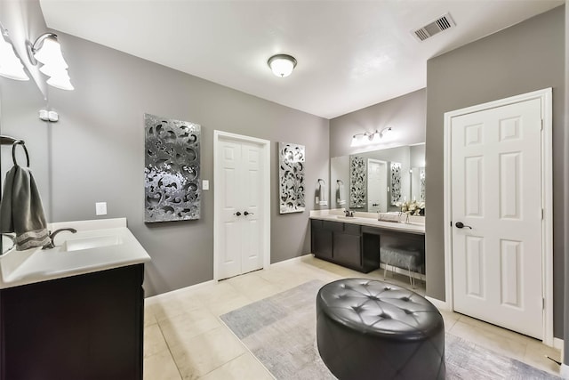 bathroom with double vanity, visible vents, a sink, and tile patterned flooring