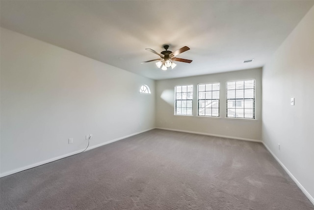 empty room featuring a ceiling fan, baseboards, and carpet