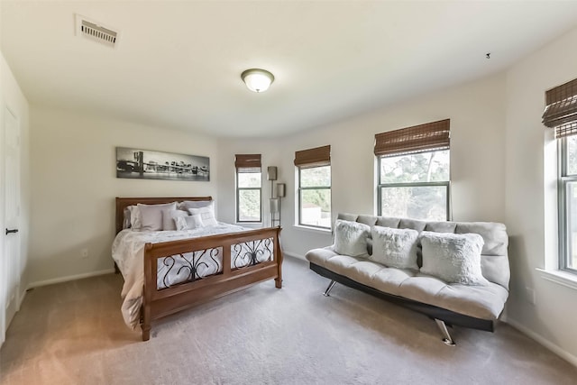 bedroom with carpet floors, baseboards, and visible vents