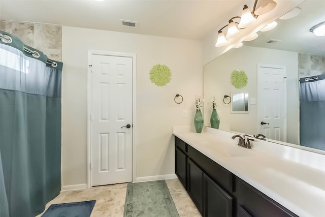 full bath featuring visible vents, baseboards, and vanity