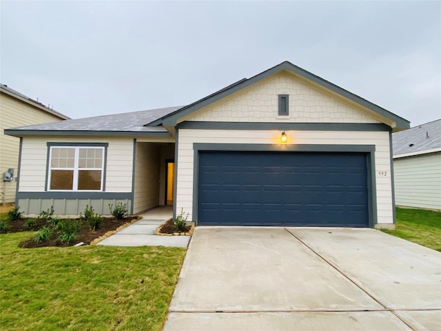ranch-style house with a front lawn, a garage, and driveway